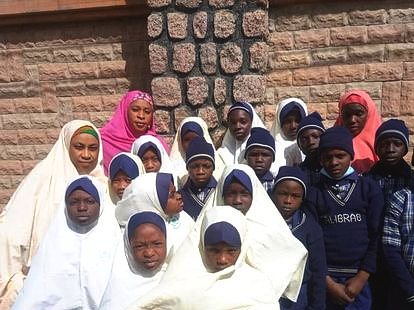 Pupils standing together outside the school building