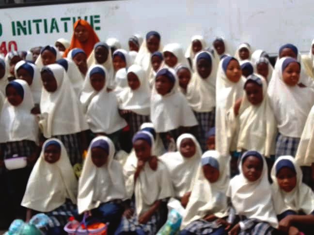 Pupils gathered beside a bus before setting off on a trip